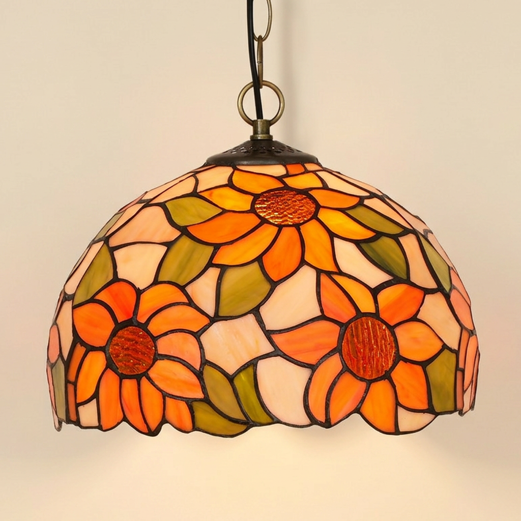 Heliette, 12 Inch Tiffany-style stained glass pendant light, lit, on a plain ivory studio background
