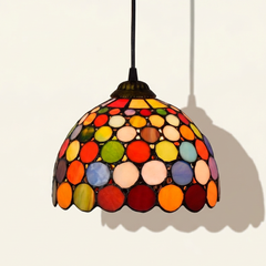 Girandole, 6-8 Inch - 8 Inches Tiffany-style stained glass pendant light, lit, on a plain ivory studio background