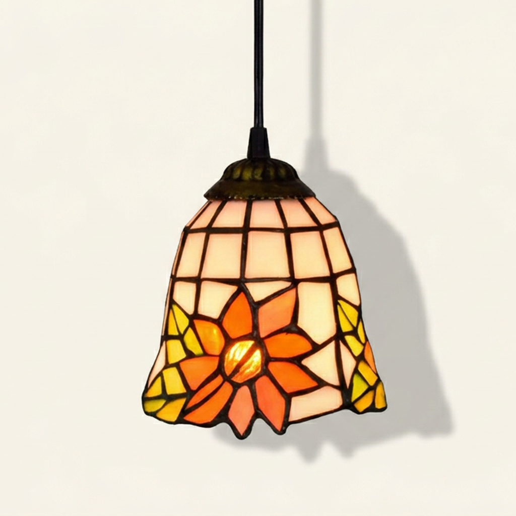 Calyx, 6 Inch Tiffany-style stained glass pendant light, lit, on a plain ivory studio background