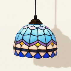 Plumaris, 6-8 Inch - 8 Inches Tiffany-style stained glass pendant light, lit, on a plain ivory studio background