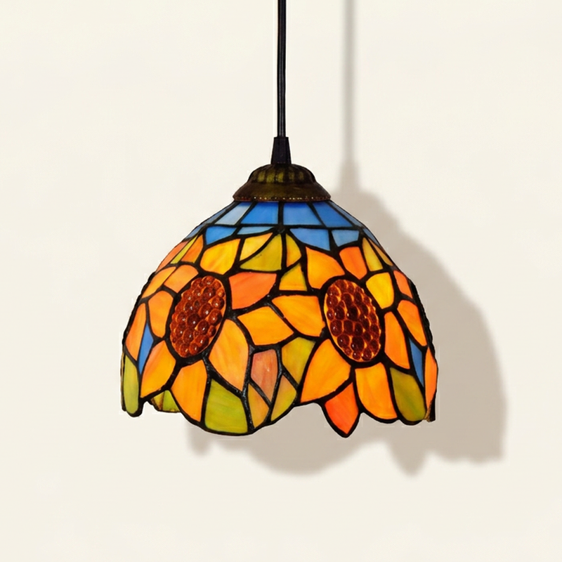 Heliette, 6-8 Inch - Blue Tiffany-style stained glass pendant light, lit, on a plain ivory studio background