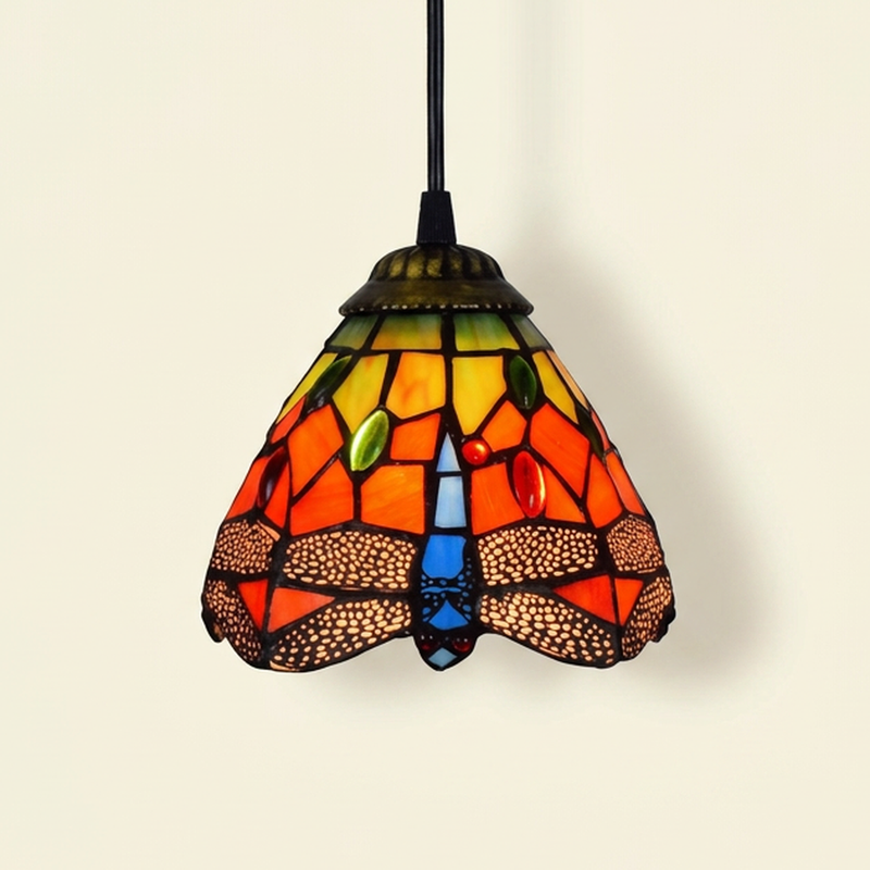 Cinnabelle, 6 Inch Tiffany-style stained glass pendant light, lit, on a plain ivory studio background