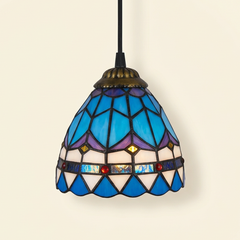 Plumaris, 6-8 Inch - 6 Inches Tiffany-style stained glass pendant light, lit, on a plain ivory studio background