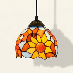 Heliette, 6-8 Inch - Light Blue, 6 Inches Tiffany-style stained glass pendant light, lit, on a plain ivory studio background