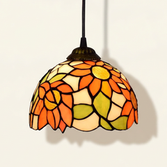 Heliette, 6-8 Inch - White Tiffany-style stained glass pendant light, lit, on a plain ivory studio background