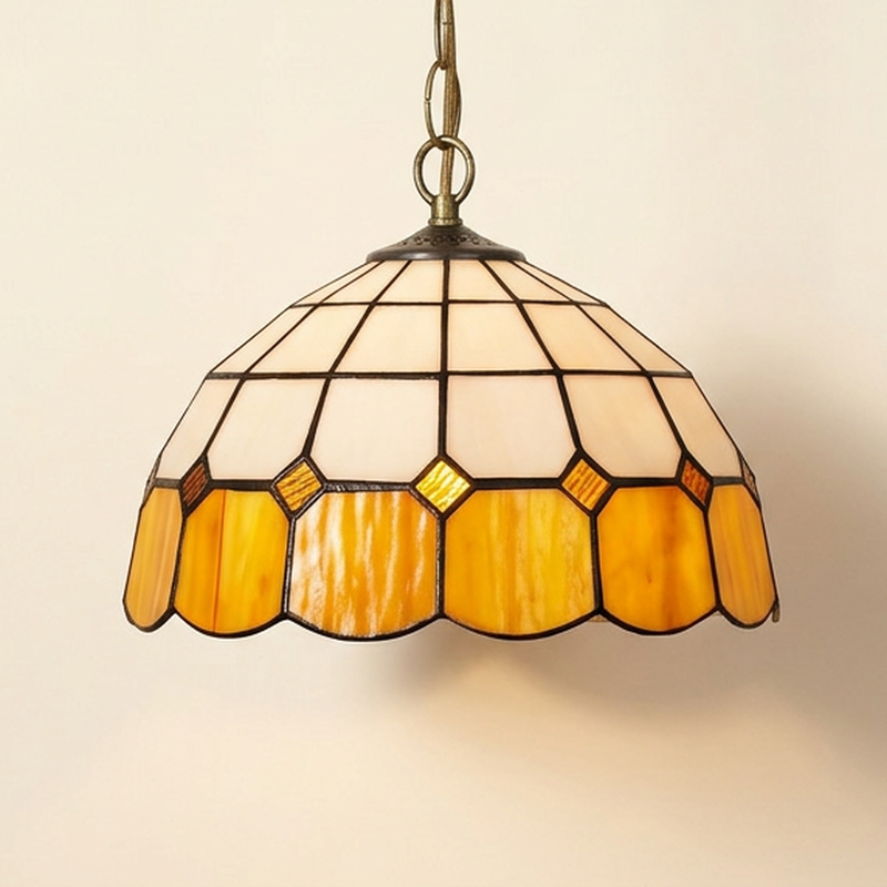 Ainsworth, 12 Inch - Yellow Tiffany-style stained glass pendant light, lit, on a plain ivory studio background