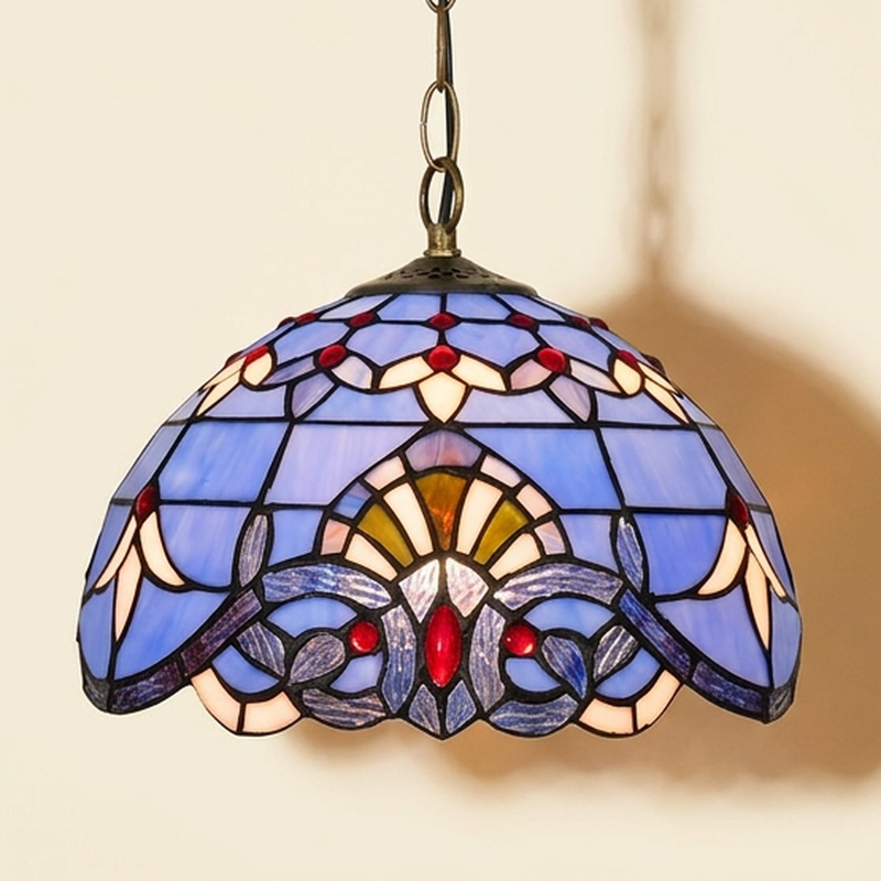Delfine, 12 Inch Tiffany-style stained glass pendant light, lit, on a plain ivory studio background