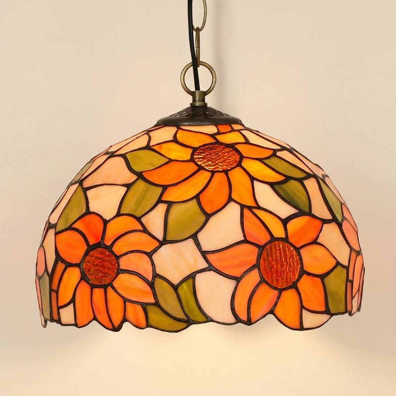 Heliette, 12 Inch Tiffany-style stained glass pendant light, lit, on a plain ivory studio background