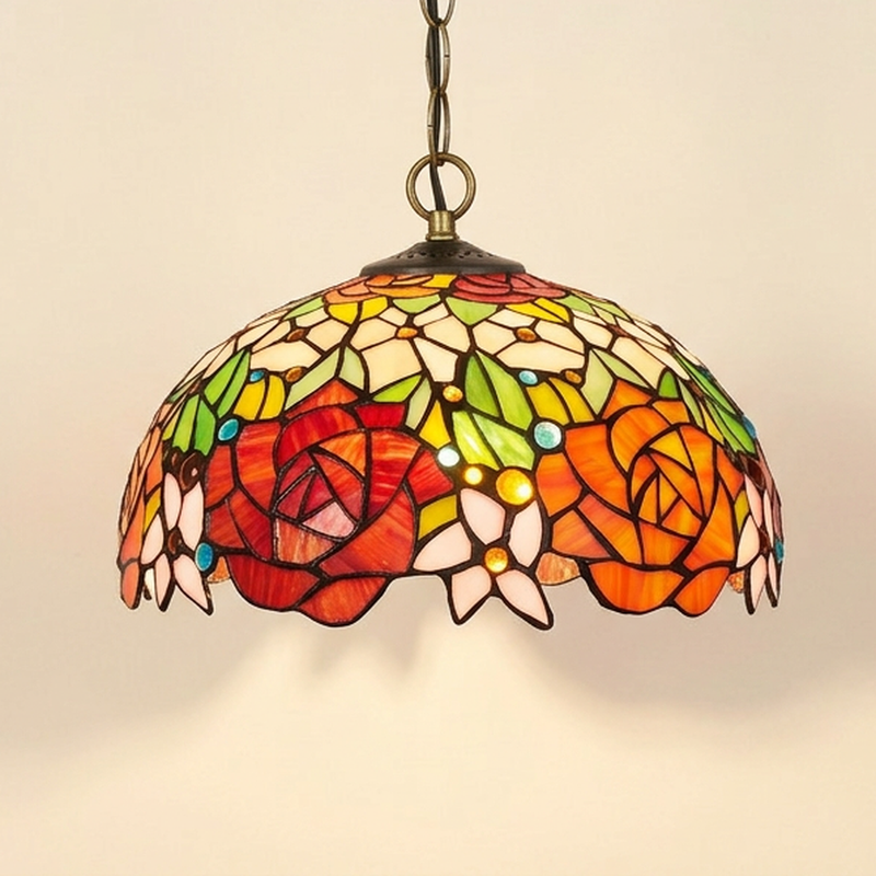 Fleuranne, 12 Inch Tiffany-style stained glass pendant light, lit, on a plain ivory studio background