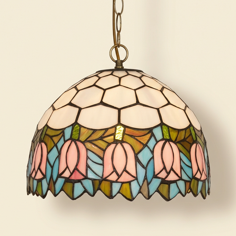 Camellie, 12 Inch Tiffany-style stained glass pendant light, lit, on a plain ivory studio background