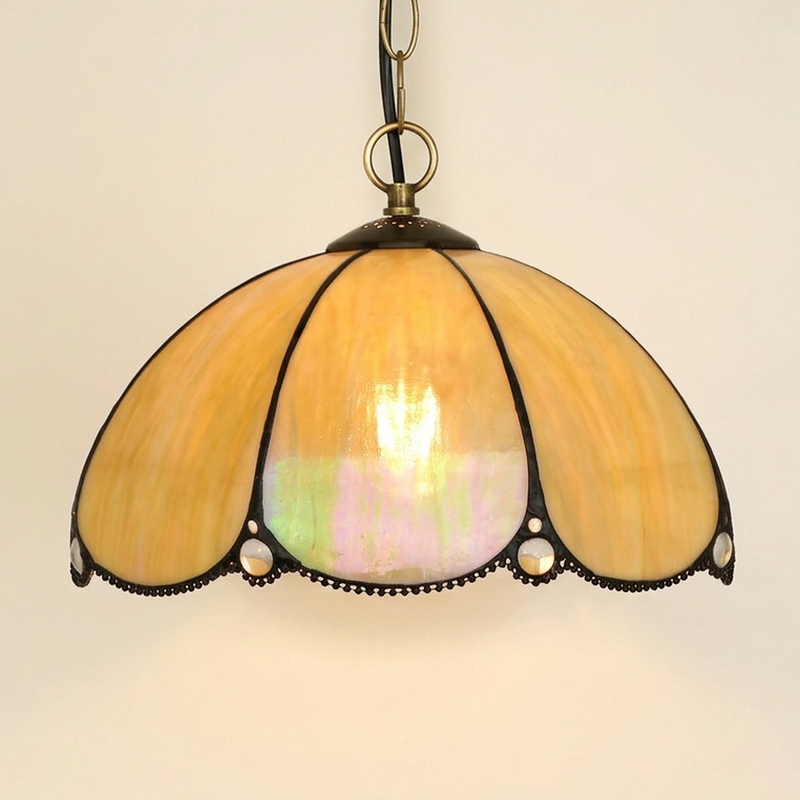 Toscana, 12 Inch Tiffany-style stained glass pendant light, lit, on a plain ivory studio background