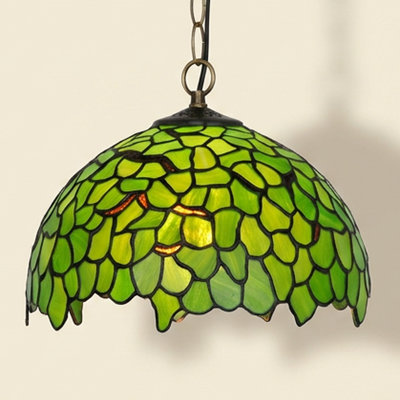 Verdaine, 12 Inch Tiffany-style stained glass pendant light, lit, on a plain ivory studio background