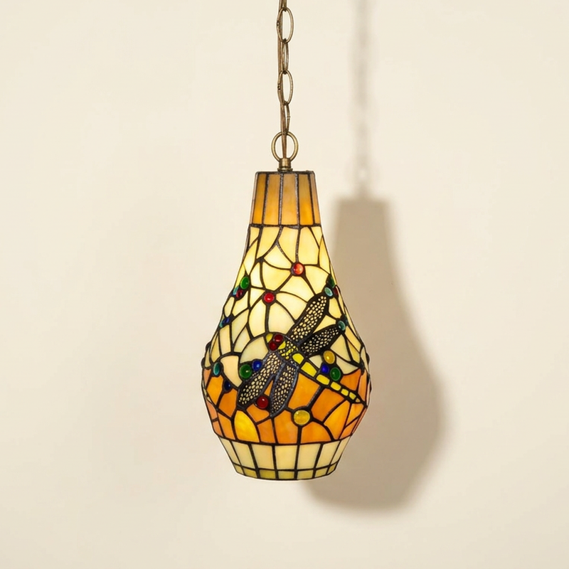 Amberis, 7 Inch Tiffany-style stained glass pendant light, lit, on a plain ivory studio background