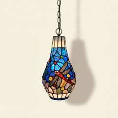 Lucienne, 7 Inch - Blue Tiffany-style stained glass pendant light, lit, on a plain ivory studio background