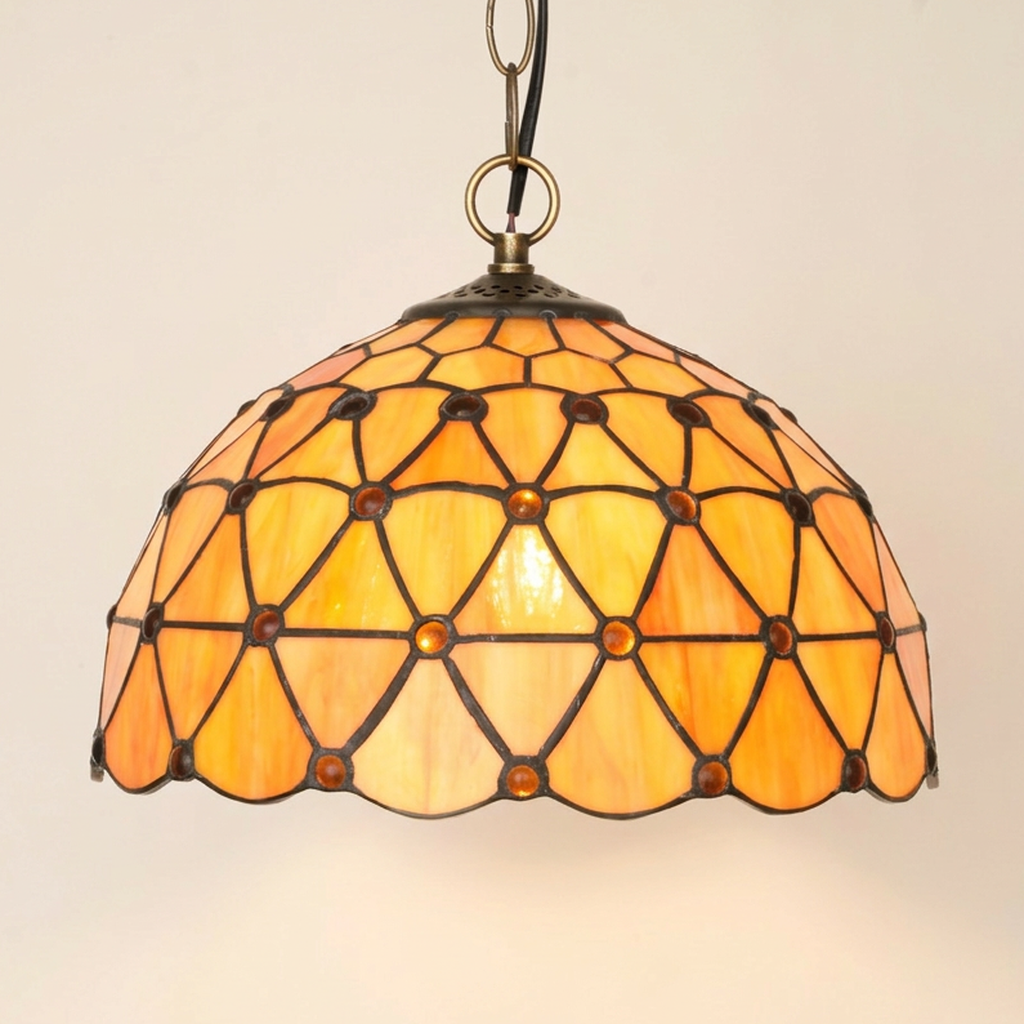 Solviane, 12 Inch Tiffany-style stained glass pendant light, lit, on a plain ivory studio background
