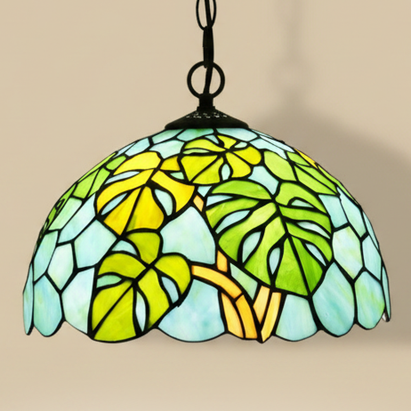 Takeda, 12 Inch Tiffany-style stained glass pendant light, lit, on a plain ivory studio background