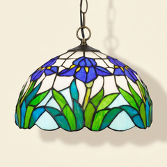 Iriselle, 12 Inch - Blue / Peach Tiffany-style stained glass pendant light, lit, on a plain ivory studio background