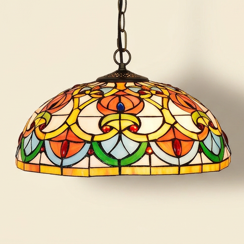Caridine, 16 Inch Tiffany-style stained glass pendant light, lit, on a plain ivory studio background