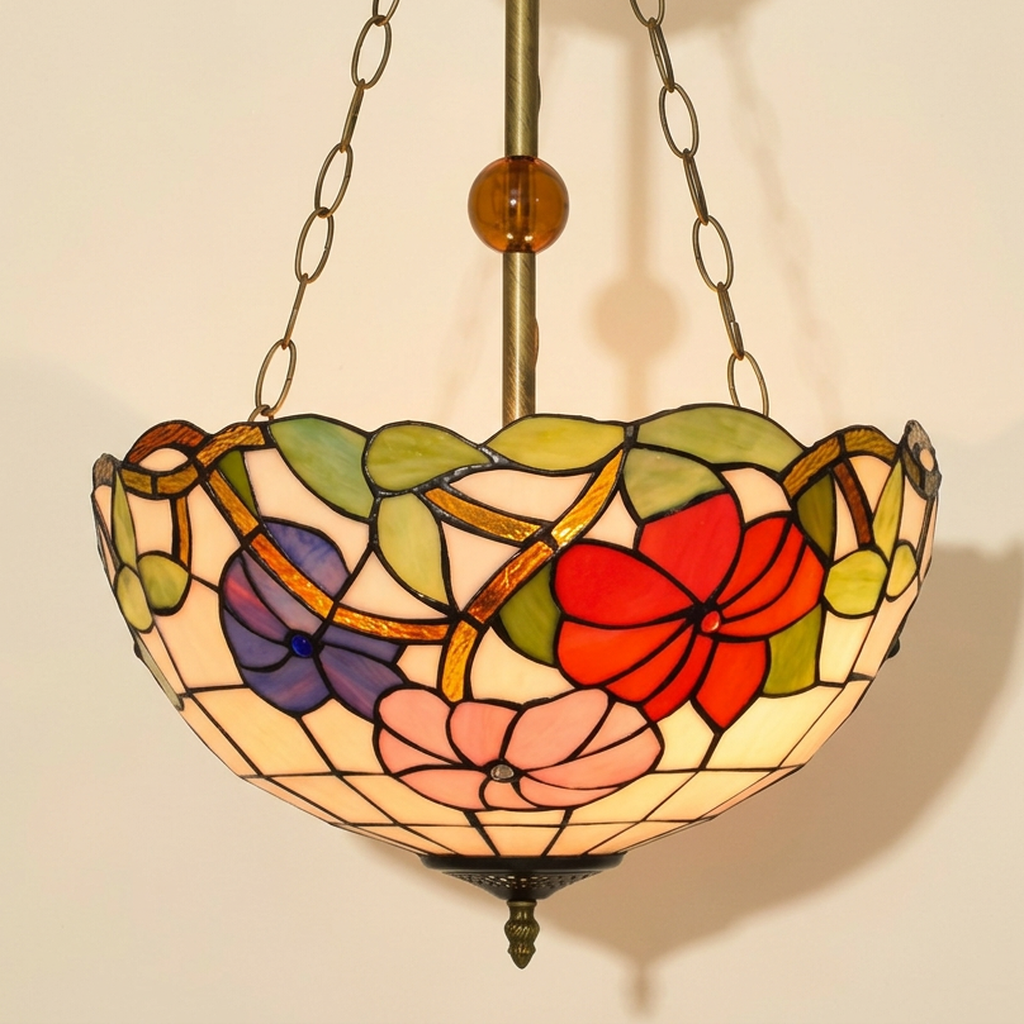 Auroria, 16 Inch Tiffany-style stained glass pendant light, lit, on a plain ivory studio background