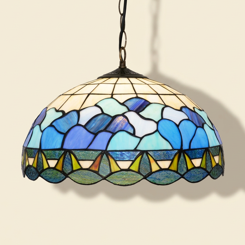 Marena, 16 Inch Tiffany-style stained glass pendant light, lit, on a plain ivory studio background