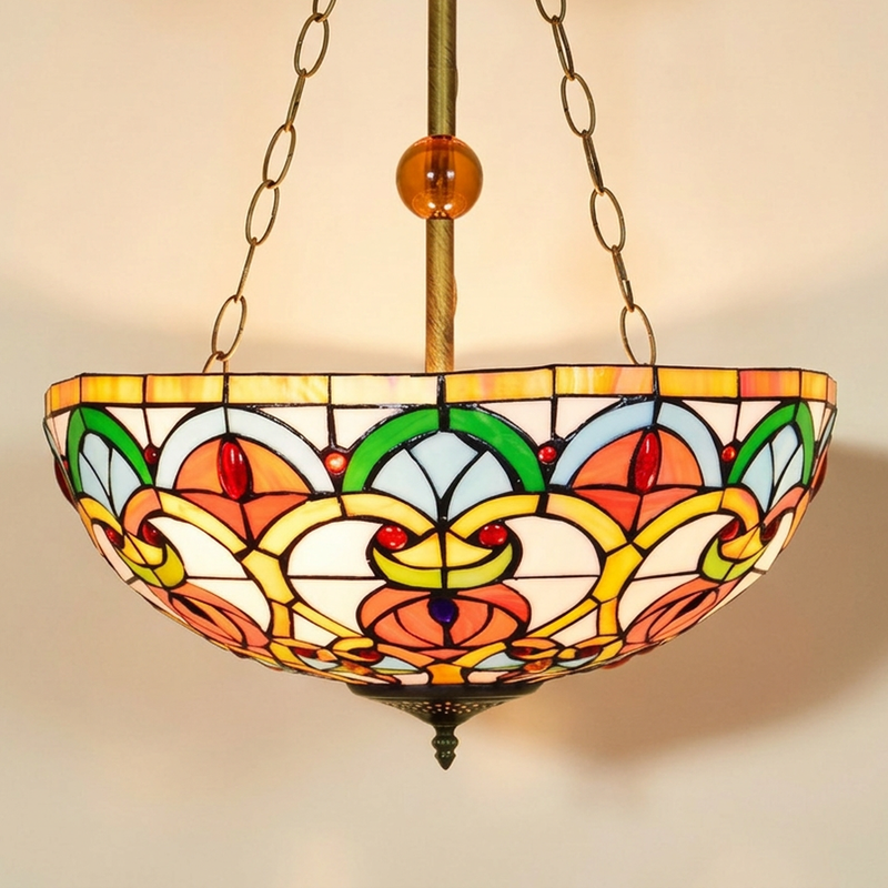 Caridelle, 16 Inch Tiffany-style stained glass pendant light, lit, on a plain ivory studio background