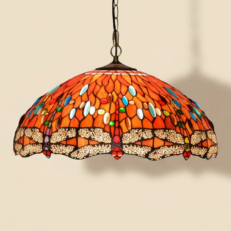 Cinnabelle, 20 Inch Tiffany-style stained glass pendant light, lit, on a plain ivory studio background
