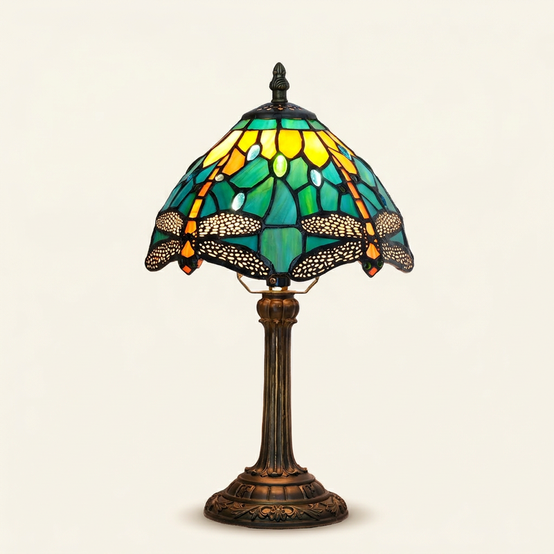 Aquelle 8 Inch Tiffany-style stained glass table lamp, lit, on a plain ivory studio background
