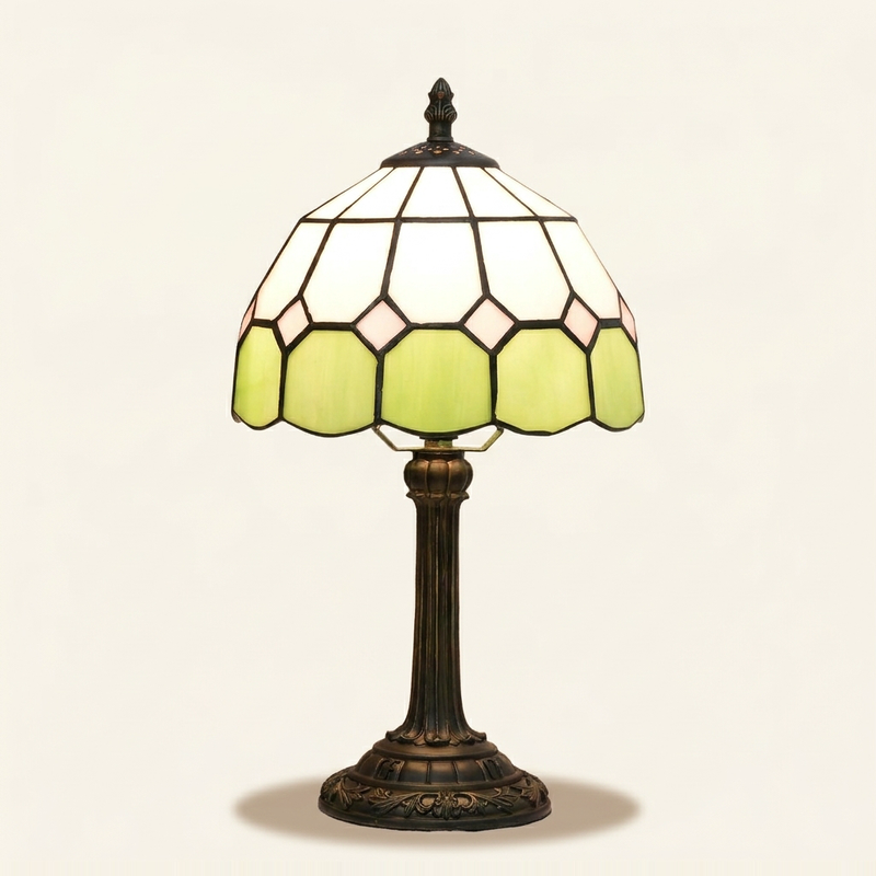 Braemar 8 Inch Tiffany-style stained glass table lamp, lit, on a plain ivory studio background