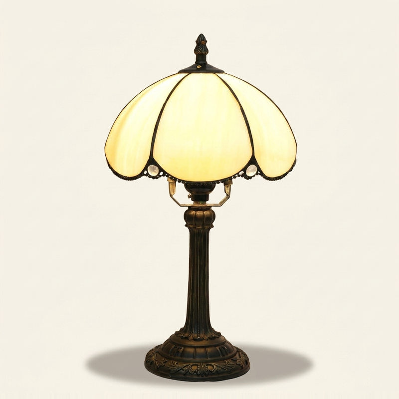 Belisse 8 Inch Tiffany-style stained glass table lamp, lit, on a plain ivory studio background