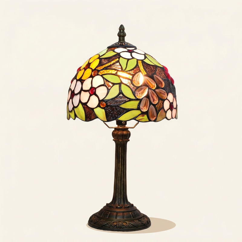 Cassindra 8 Inch Tiffany-style stained glass table lamp, lit, on a plain ivory studio background