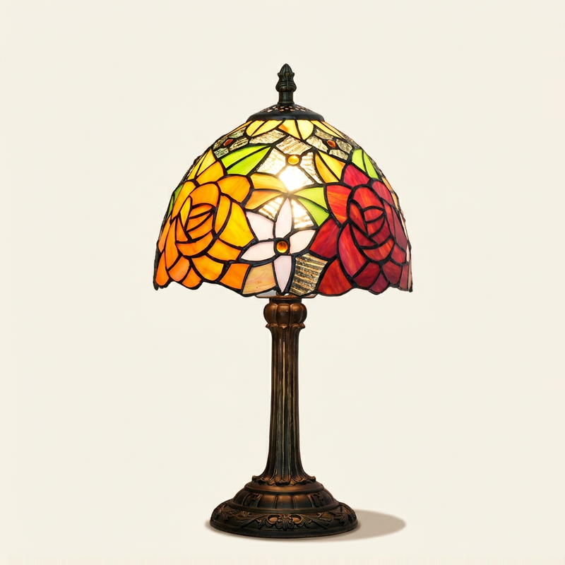 Marisol 8 Inch Tiffany-style stained glass table lamp, lit, on a plain ivory studio background