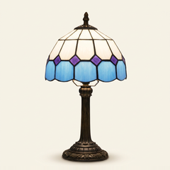 Ainsley 8 Inch Tiffany-style stained glass table lamp, Straight Pole base, lit, on a plain ivory studio background