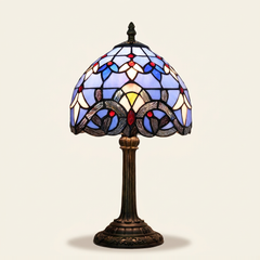 Bellamont 8 Inch Tiffany-style stained glass table lamp, Straight Pole base, lit, on a plain ivory studio background
