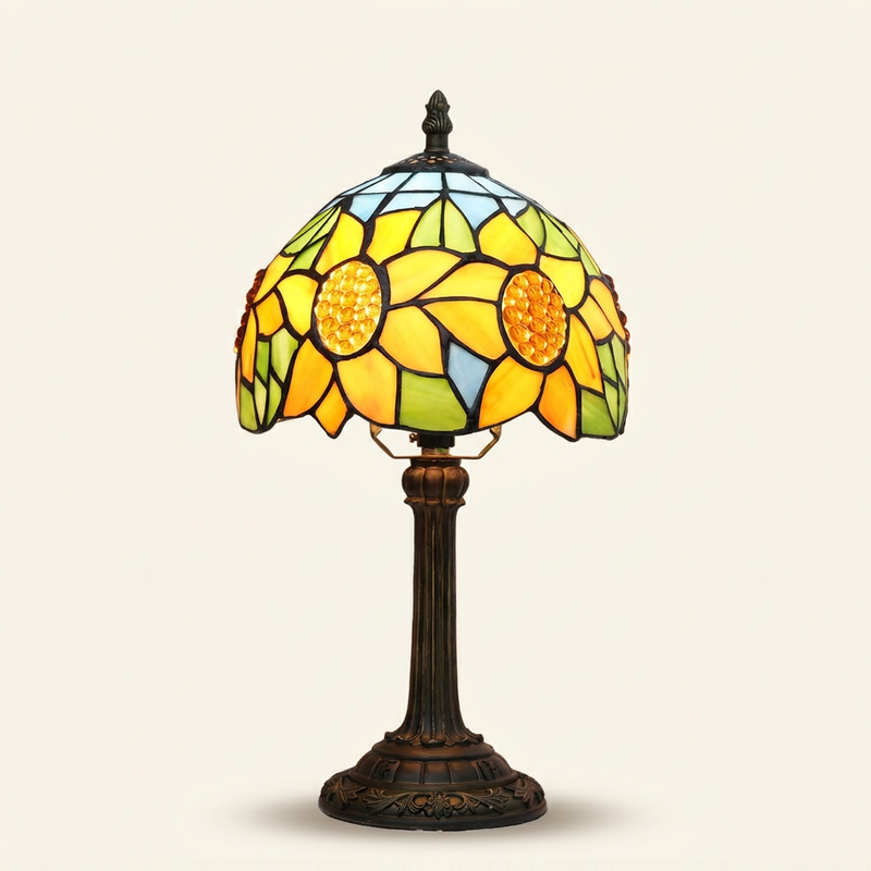Celestine 8 Inch Tiffany-style stained glass table lamp, lit, on a plain ivory studio background