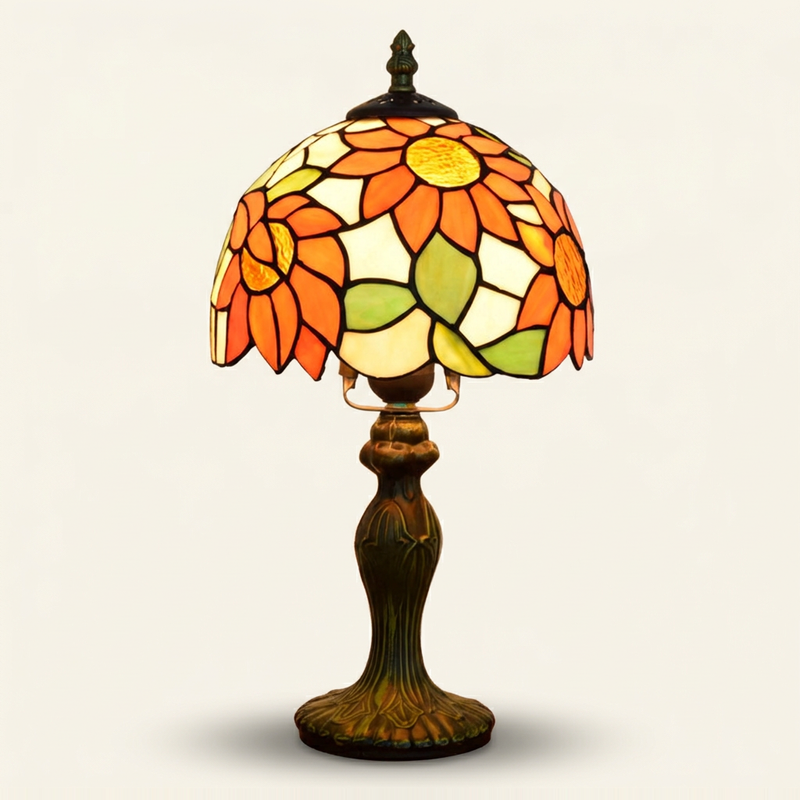 Blanchette 8 Inch Tiffany-style stained glass table lamp, lit, on a plain ivory studio background