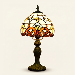 Marchesa 8 Inch Tiffany-style stained glass table lamp, Curved Pole base, lit, on a plain ivory studio background