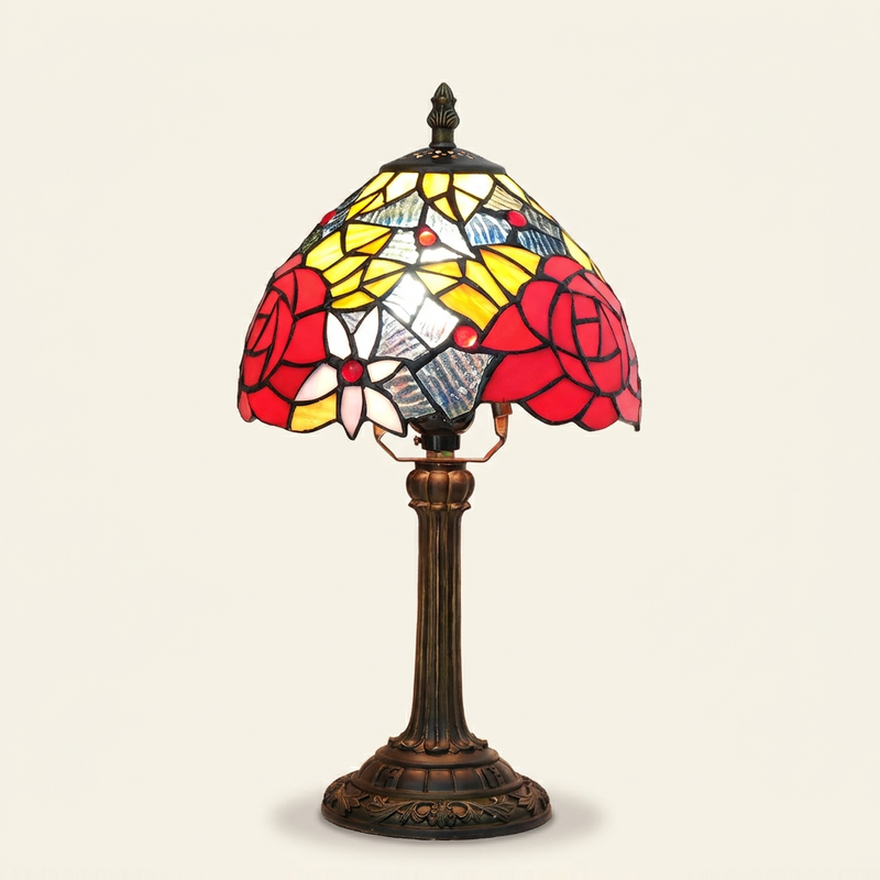 Vermeille 8 Inch Tiffany-style stained glass table lamp, lit, on a plain ivory studio background