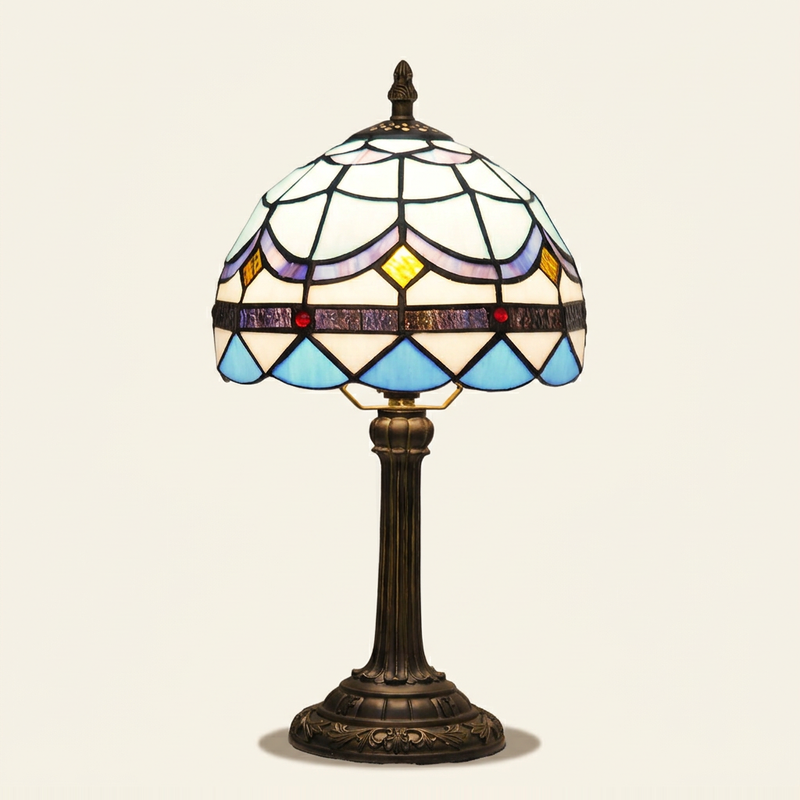 Azurel 8 Inch Tiffany-style stained glass table lamp, lit, on a plain ivory studio background