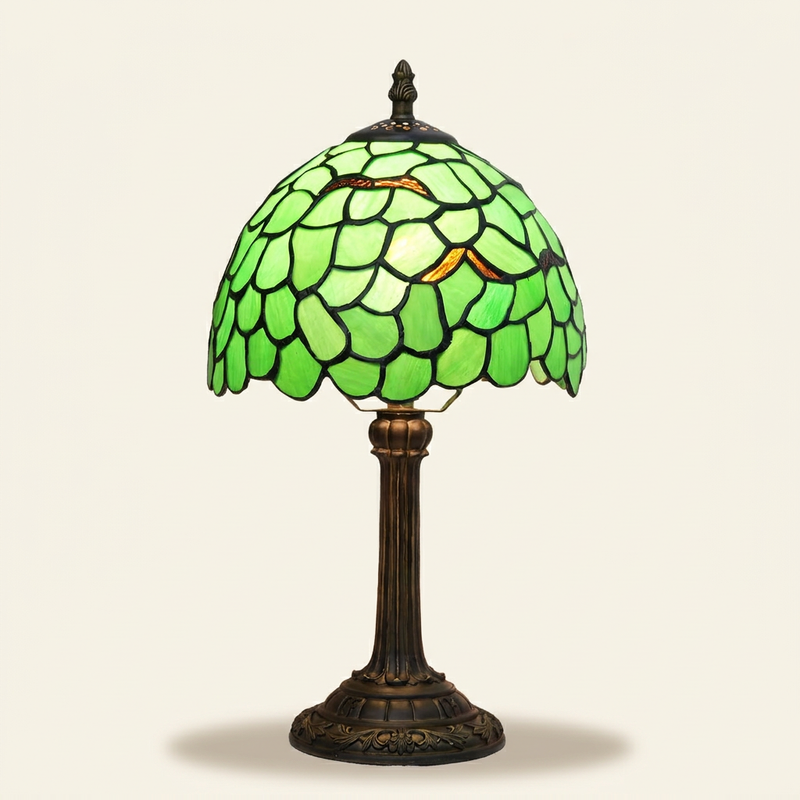 Verdelle 8 Inch Tiffany-style stained glass table lamp, lit, on a plain ivory studio background
