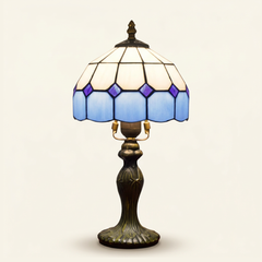 Ainsley 8 Inch Tiffany-style stained glass table lamp, Curved Pole base, lit, on a plain ivory studio background