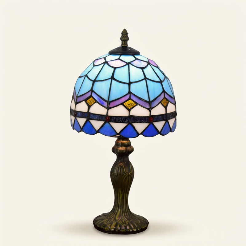 Rivera 8 Inch Tiffany-style stained glass table lamp, lit, on a plain ivory studio background