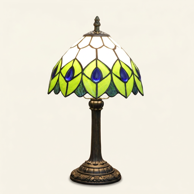 Almira 8 Inch Tiffany-style stained glass table lamp, lit, on a plain ivory studio background