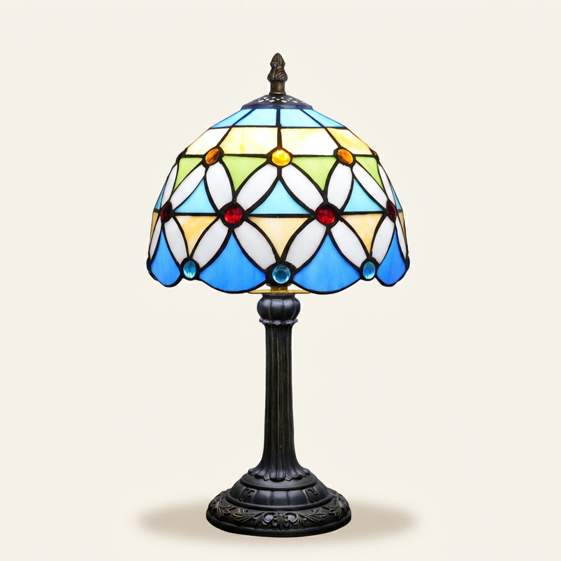 Calliope 8 Inch Tiffany-style stained glass table lamp, lit, on a plain ivory studio background