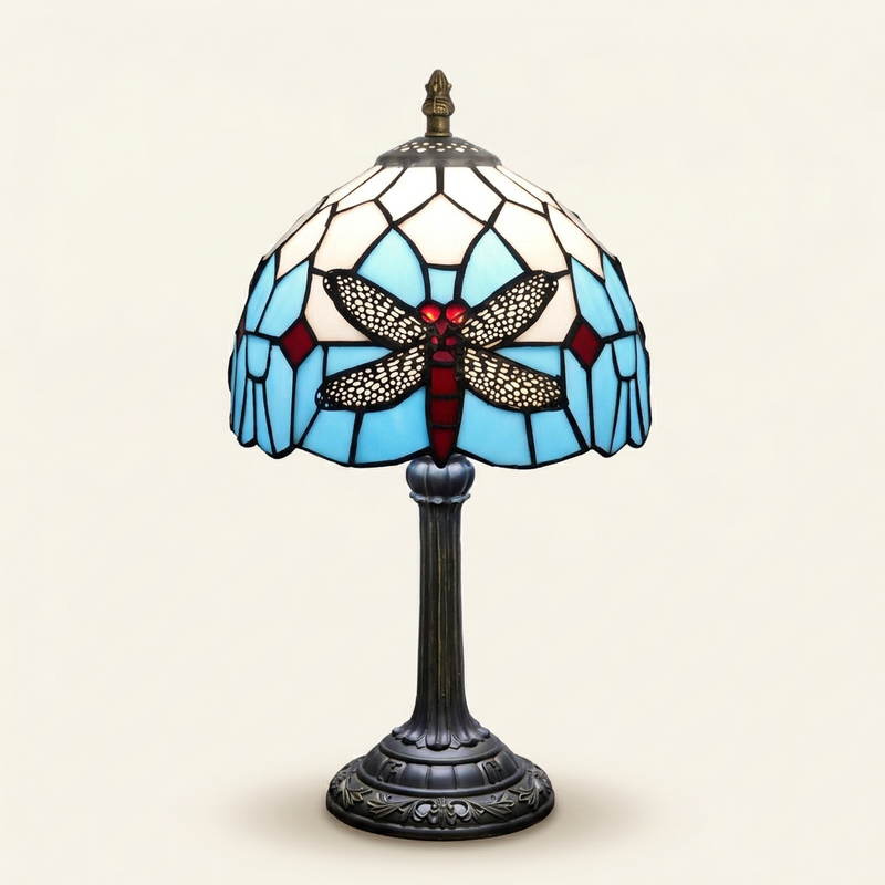 Elmira 8 Inch Tiffany-style stained glass table lamp, lit, on a plain ivory studio background