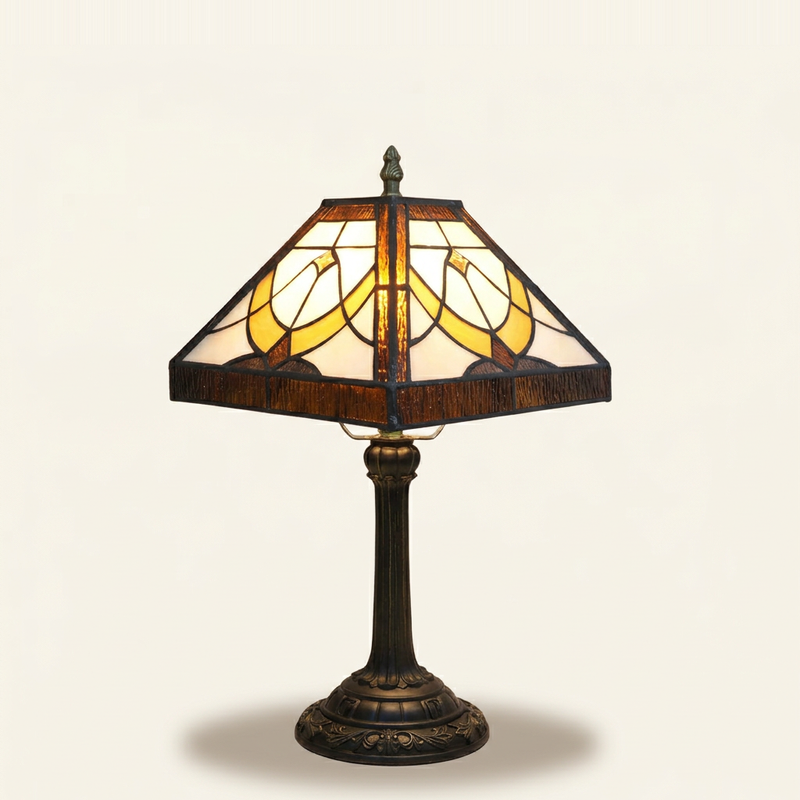 Anchora 11 Inch Tiffany-style stained glass table lamp, lit, on a plain ivory studio background