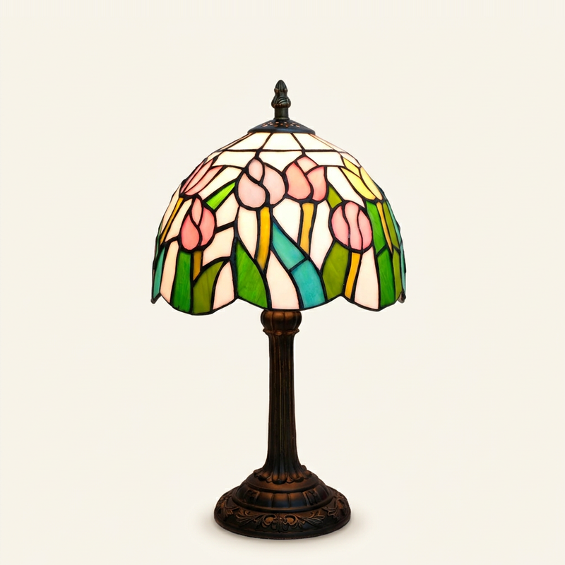 Tulippa 8 Inch Tiffany-style stained glass table lamp, lit, on a plain ivory studio background