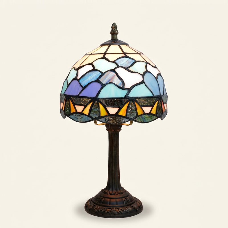 Marisole 8 Inch Tiffany-style stained glass table lamp, lit, on a plain ivory studio background