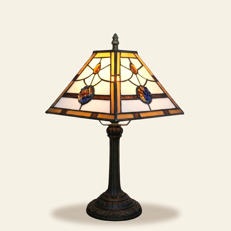 Windsora 11 Inch Tiffany-style stained glass table lamp, lit, on a plain ivory studio background