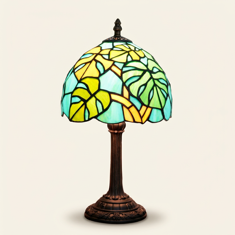 Takara 8 Inch Tiffany-style stained glass table lamp, lit, on a plain ivory studio background