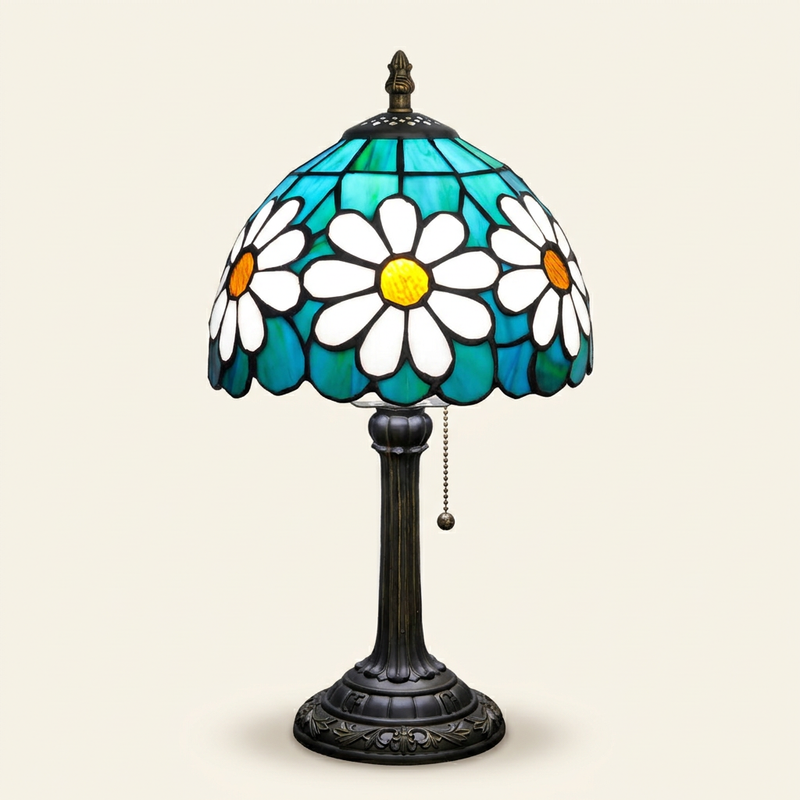 Chrysanthe 8 Inch Tiffany-style stained glass table lamp, lit, on a plain ivory studio background